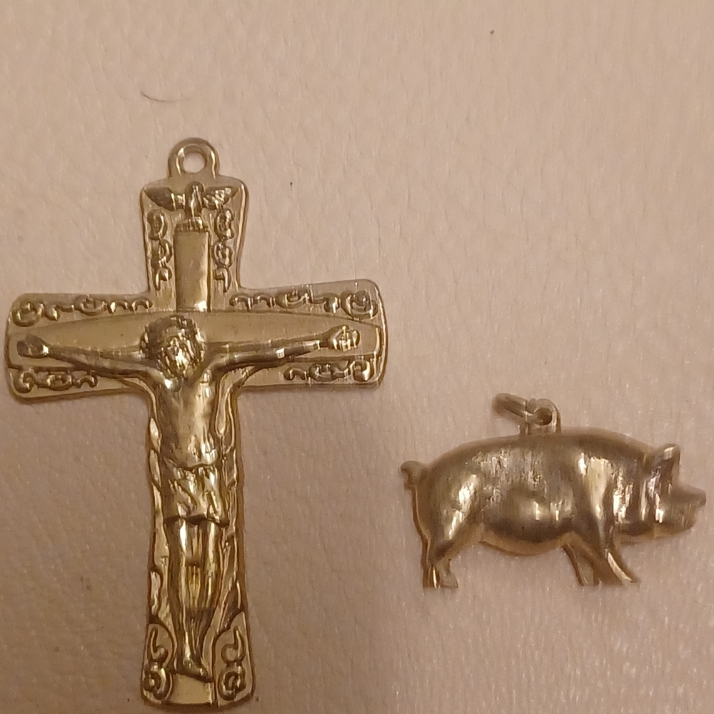 Gold cross and pig pendants